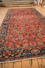 Perspective view of a vintage Heriz runner's geometric arabesques and rich navy blue border.