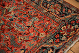 Detail of a vintage Heriz rug showing low pile with visible knot heads and rich gem tones.