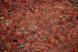 Detailed texture of a vintage Heriz rug's interconnected serrated leaves and geometric arabesques.