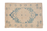 Distressed Oushak rug, faded sky blue medallion with corner spandrels on an abrashed ivory ground, 2'6