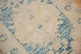 Decorative distressed Oushak rug pile with sky blue and ivory faded floral motifs.