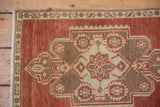 Distressed Turkish Oushak rug corner, rust, coffee, ivory geometric floral border detail.