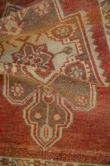 Vintage distressed Oushak rug pile detail, with rust, coffee brown, and ivory geometric patterns.
