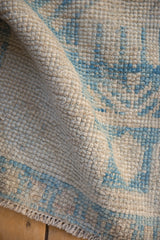 Evenly worn knot heads showing the ivory and sky blue texture of a hand-knotted Oushak rug.