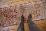 Vintage Distressed Oushak runner with faded camel pile, red pomegranate blossoms, and abrashes.