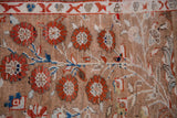 Red pomegranate blossoms, navy accents, and Chintamani border on distressed Oushak pile.