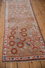 Distressed Oushak rug runner close-up showing red pomegranate blossoms and Chintamani border.