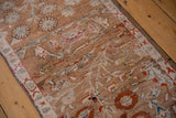 Worn Oushak pile with abrashes, revealing soft camel, pale blue, and pink patterns.