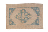 Distressed Oushak rug with a sky blue central medallion and corner spandrels on a textured ivory field.