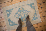 Overhead view showing the scale and evenly worn texture of a distressed Oushak rug.