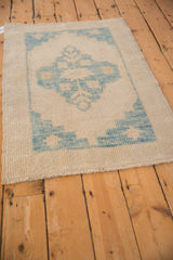 Intact side cord and textured, low pile on the corner of a distressed Oushak rug.