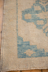 Detailed view of the distressed texture, showing the hand-knotted pile and intact side cord.
