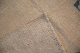Detail of the hand-knotted foundation and machine-bound edge of the vintage Oushak carpet.