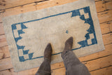 Distressed vintage Oushak runner, textured ivory pile, worn cobalt blue serrated pattern.