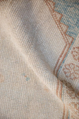 Distressed Oushak rug detail: low pile, worn knot heads, subtle ivory, pale brown, powder blue.