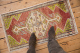 Vibrant distressed Oushak rug mat, geometric medallion in terra cotta, lime green, ivory.
