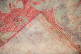 Vintage Distressed Oushak rug's tight beige foundation weave and red machine-bound edge.