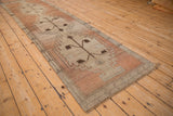 Distressed Oushak rug runner with a copper and sandalwood stepped geometric floral medallion.