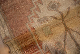 Distressed vintage Oushak rug runner pile, showing even wear and muted geometric patterns.