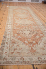 Angled detail of the distressed Oushak runner, revealing pale copper and sand tones with textured pile.