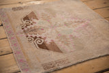 Distressed Oushak rug pile with sand, beige, and fuchsia color pops.