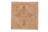 Distressed Oushak square rug with blossomed quatrefoil medallion, scrolled tendrils, sand, and pink tones. 2'2