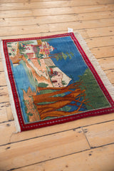 Angled view of a vintage Persian tableau rug showing the full pictorial landscape.