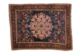 Antique Kurdish Bijar rug with a roundel medallion on a navy field, featuring boteh and palmette designs.