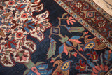 Detailed border with boteh and Samovar motifs on a navy blue antique Kurdish Bijar rug.