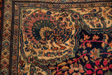 Corner spandrel of an antique Farahan Sarouk carpet with a stylized peacock in jade and mauve.