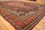 Stylized peacock motif within the sand-colored spandrel of an antique Persian Farahan Sarouk carpet.