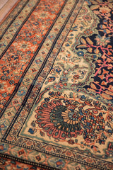 Intricate peacock motif within the corner spandrel of an antique Farahan Sarouk carpet.