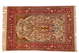 Antique Isfahan rug with a detailed Tree of Life, ivory field, and a red pictorial border showing birds and animals.