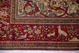 Finely knotted deer and birds within the cochineal red floral border of a collector Persian Isfahan rug.