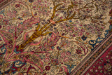 High-density knotting details perched birds and floral vines in an antique Persian Isfahan rug.