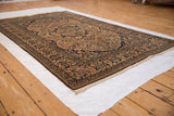 Low angle view of a Mohtashem Kashan rug showing its dense, even pile and classic medallion design.