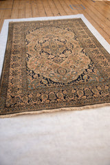 Angled view of an antique Mohtashem Kashan rug showcasing its remarkable condition and plush, full pile.