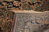 Corner of an antique Mohtashem Kashan rug showing the fine weave, dense pile, and original purple side cord.