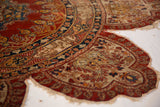 Fragile tattered edge of an antique silk Tabriz rug, detailing the intricate boteh designs and literary inscription band.