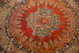 Center inscription of a silk Tabriz collector rug surrounded by a sky blue and rust red floral medallion.