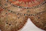 A split and tattered edge on a silk Tabriz rug, showing detailed border inscriptions and motifs.