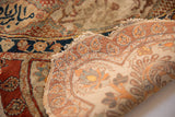 A folded corner of a late 19th-century silk Tabriz showing its fine weave and fragile edge.