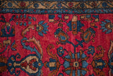 Golden-shaded border next to a raspberry red field with sapphire blue and copper floral motifs.