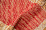 Detail showing the even wear and soft texture of a distressed Oushak rug's red and saffron lattice pile.