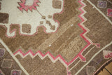 Even wear and hand-knotted texture of a distressed Turkish Kars rug with geometric motifs.