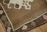 Evenly worn, hand-knotted wool pile on the corner of a distressed vintage Turkish Kars rug.