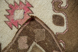 Corner of a vintage Kars rug folded to show the hand-knotted foundation and textured wool pile.