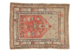 Distressed Oushak rug with a blush prayer design, jade field, and multiple geometric borders.