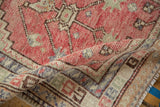 A close-up of the distressed Oushak rug's supple weave and even wear to the knot heads.