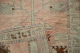 Hand-knotted back and secured selvage detail on a vintage distressed Oushak rug.